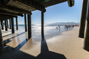 Motion blured water and under popular Santa Monica Pier near Los Angeles in Southern California.