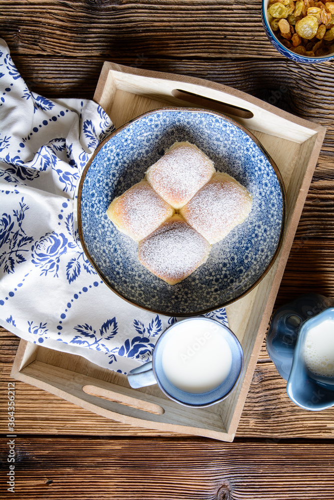 Wall mural Sweet yeast buns stuffed with curd, raisins and studded with powdered sugar