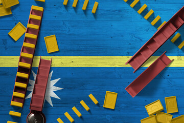 Nauru flag with national background with dominoes on wooden table. Top view. Concept of game.