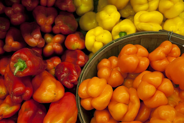 Fototapeta na wymiar Multicolored bell peppers on display in market