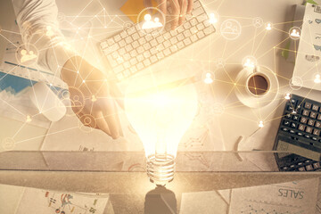 Double exposure of man's hands typing over computer keyboard and social network theme hologram drawing. Top view. People connection web concept.