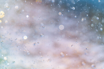 Splashing water in the rays of sunlight. Fun on the beach, background