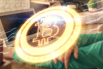 Double exposure of man and woman working together and crypto finance theme hologram. Blockchain...