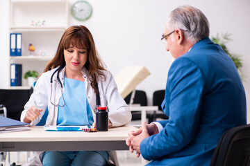 Old businessman visiting young female doctor