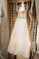 wedding dress hanging from the ceiling inside the house