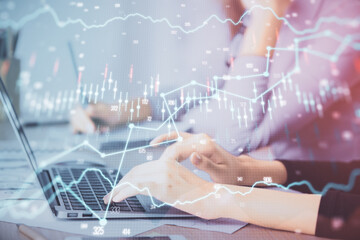 Multi exposure of woman hands typing on computer and financial chart hologram drawing. Stock market analysis concept.