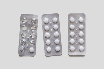 Blister packs with white tablets on a light background