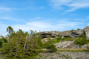 Fototapeta na wymiar Limestone cliff face under blue cloudy sky