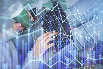 Double exposure of woman hands typing on computer and forex chart hologram drawing. Stock market invest concept.