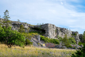 Limestone cliff face under blue cloudy sky