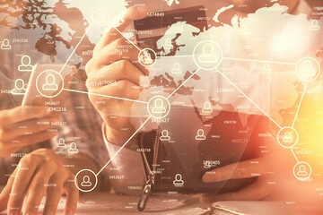 Double exposure of man and woman on-line shopping holding a credit card and social network theme hologram drawing. People connecting and E-commerce pay on-line concept.