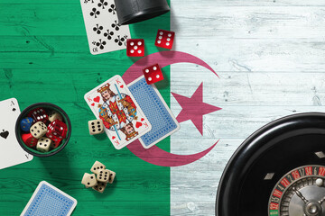 Algeria casino theme. Aces in poker game, cards and chips on red table with national wooden flag background. Gambling and betting.