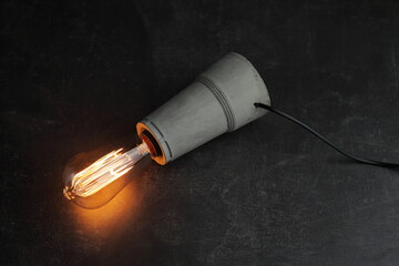 Retro lamp with Edison lamp on concrete. A good idea