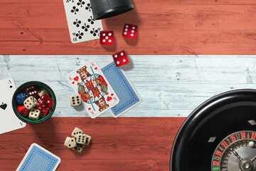 Austria casino theme. Aces in poker game, cards and chips on red table with national wooden flag background. Gambling and betting.