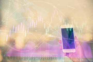 Double exposure of forex chart sketch hologram and woman holding and using a mobile device. Stock market concept.