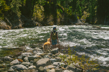 Male Hiker With Dog At The River