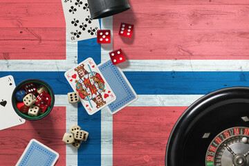 Bouvet Islands casino theme. Aces in poker game, cards and chips on red table with national wooden flag background. Gambling and betting.