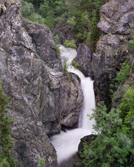 Cascading waterfall with rock face sides in northern Canada, Yukon Territory. Taken in the summer. 