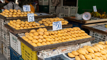selling fresh mangoes in a market in Asia. Mango is the most popular fruit in Asia.