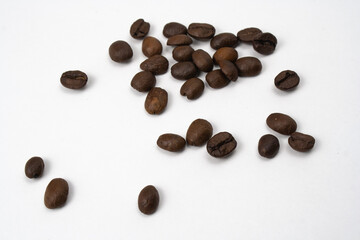Wooden spoon with brown grains of wheat in the middle on white isolated background. Oats rye barley. Top view. Closeup. Banner for web site