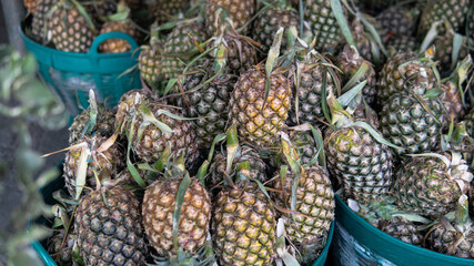 .selling pineapple fruits in tropical markets in Asia. World imports of pineapples and exotic fruits