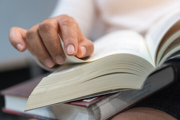 Reading book, opening books for education learning in textbook literature in home or academic on...