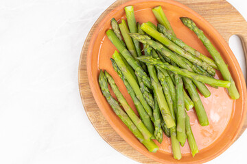 Cooked asparagus on the wooden board