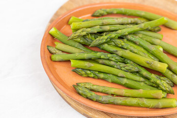 Cooked asparagus on the wooden board