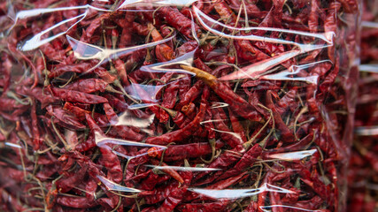 Fototapeta premium selling red hot peppers in pods in the Asian market. The sharpest red pepper in the world
