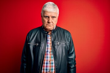 Senior handsome hoary man wearing casual shirt and jacket over isolated red background depressed...