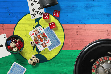 New Caledonia casino theme. Aces in poker game, cards and chips on red table with national wooden flag background. Gambling and betting.