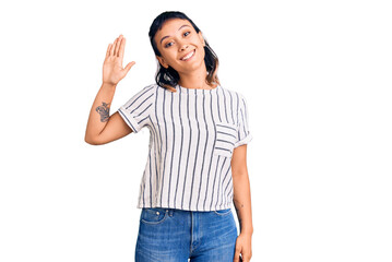 Obraz premium Young woman wearing casual clothes waiving saying hello happy and smiling, friendly welcome gesture