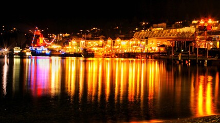 Fototapeta na wymiar Queenstown night lights reflected on lake Wakatipu