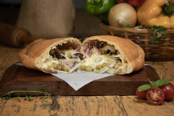 Fogazza with Portuguese filling, catupiry cheese, peas, onions, mozzarella cheese, ham and egg