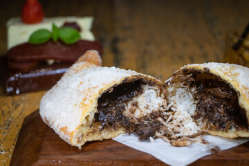 Sweet fogazza stuffed with prestige, chocolate and grated coconut