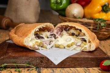 Fogazza with Portuguese filling, catupiry cheese, peas, onions, mozzarella cheese, ham and egg