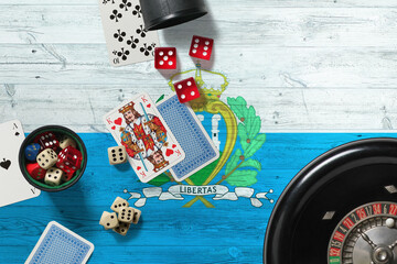 San Marino casino theme. Aces in poker game, cards and chips on red table with national wooden flag background. Gambling and betting.