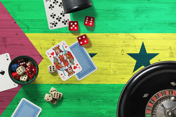 Sao Tome And Principe casino theme. Aces in poker game, cards and chips on red table with national wooden flag background. Gambling and betting.