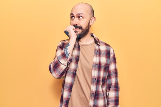 Young handsome man wearing casual clothes looking stressed and nervous with hands on mouth biting nails. anxiety problem.