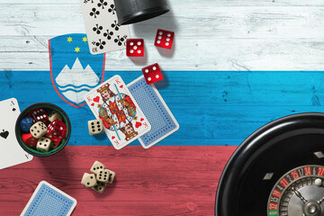Slovenia casino theme. Aces in poker game, cards and chips on red table with national wooden flag background. Gambling and betting.