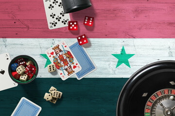 Syria casino theme. Aces in poker game, cards and chips on red table with national wooden flag background. Gambling and betting.
