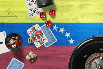 Venezuela casino theme. Aces in poker game, cards and chips on red table with national wooden flag background. Gambling and betting.