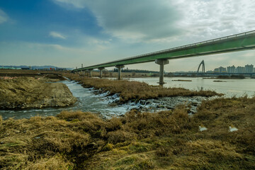 River landscape with buildings and bridge