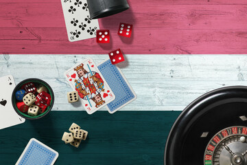 Yemen casino theme. Aces in poker game, cards and chips on red table with national wooden flag background. Gambling and betting.