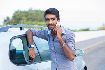 Naklejka premium Happy handsome young man talking on mobile phone