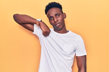 Young african american man wearing casual clothes strong person showing arm muscle, confident and proud of power