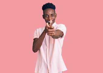 Young african american man wearing casual clothes pointing fingers to camera with happy and funny face. good energy and vibes.