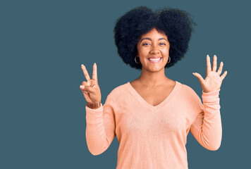 Young african american girl wearing casual clothes showing and pointing up with fingers number seven while smiling confident and happy.