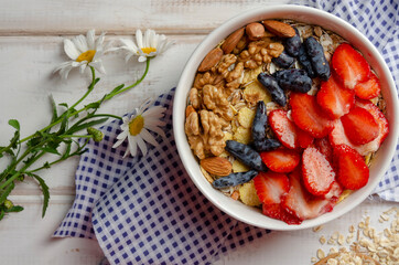 Obraz na płótnie Canvas Homemade muesli bowl with strawberry, banana, nuts