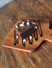 Homemade Chocolate brownie topping with marshmallow on wooden background